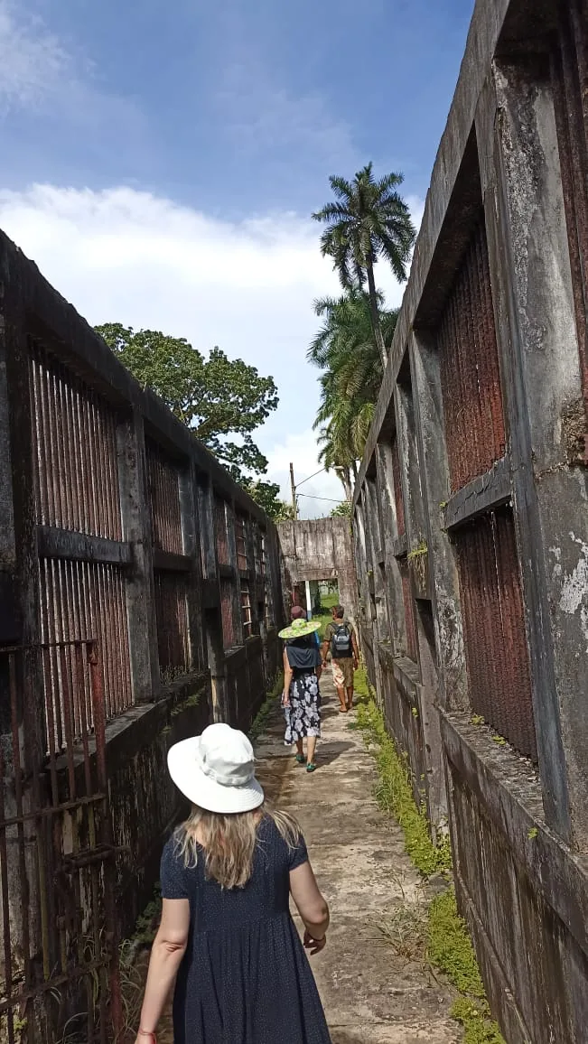 Visitors walking through the old Coiba prison ruins — archive photo from when tours were allowed