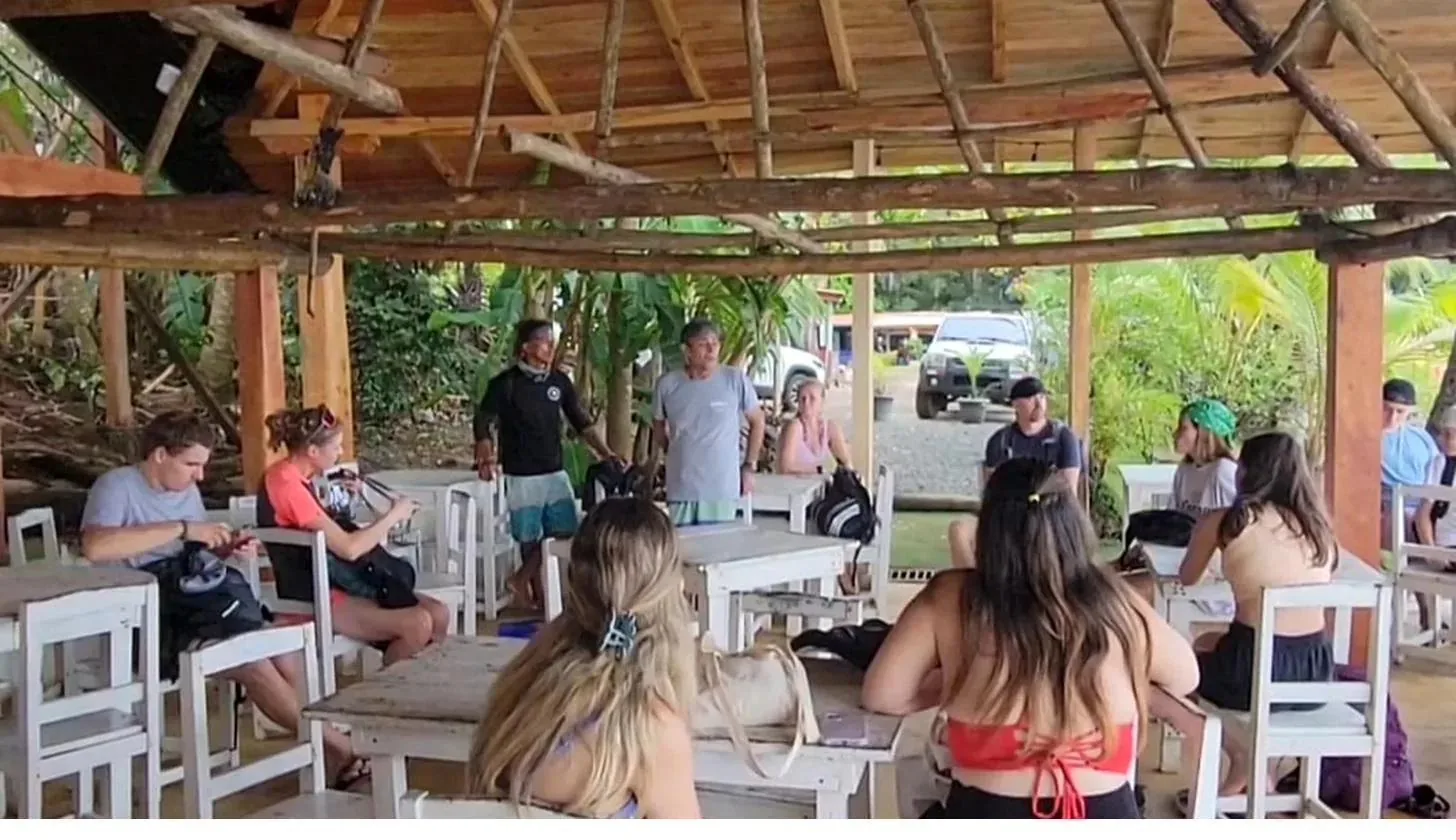 Travelers gathering for a tour briefing at a restaurant in Santa Catalina, Panama